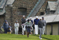 Dustin Johnson, second from right, walks down the 10th hole fairway during practice for the U.S. Open Championship golf tournament at Winged Foot Golf Club, Tuesday, Sept. 15, 2020, in Mamaroneck, N.Y. (AP Photo/John Minchillo)