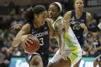 Connecticut's Megan Walker, left, drives past South Florida's Shae Leverett during the second half of an NCAA college basketball game Sunday, Feb. 16, 2020, in Tampa, Fla. (AP Photo/Mike Carlson)