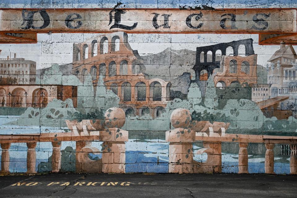 A mural covers the side of a structure in the parking lot of DeLuca's restaurant photographed on Thursday, Oct. 21, 2021, in Lansing.