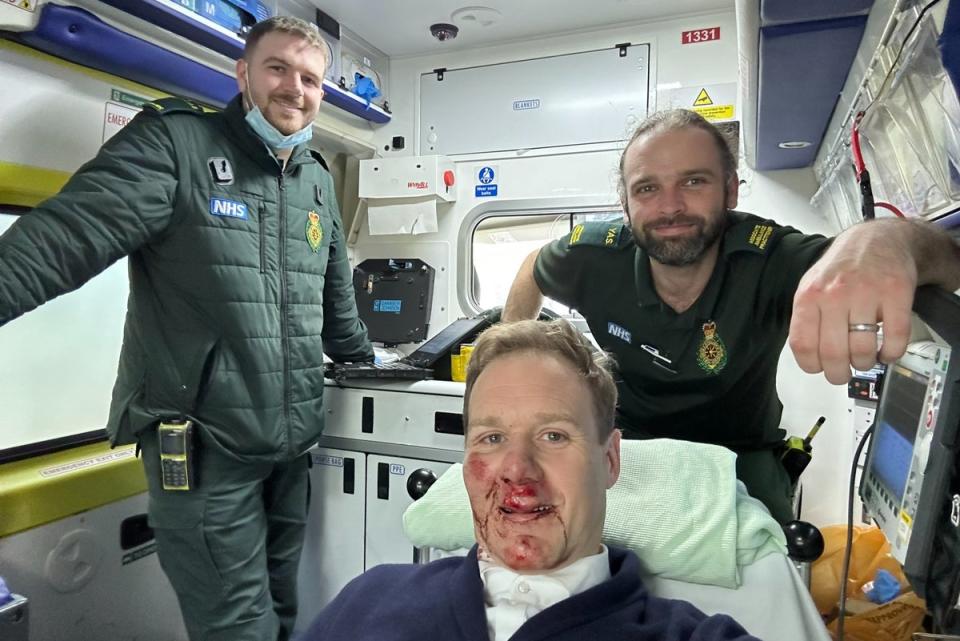 Walker with his injuries and paramedics shortly after his accident last week (@mrdanwalker/Twitter)