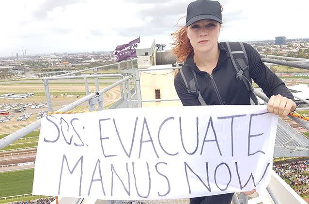 Two woman climbed a crane near the Flemington race track to unfurl a banner in protest. Pictures: Whistleblowers, Activists and Citizens Alliance