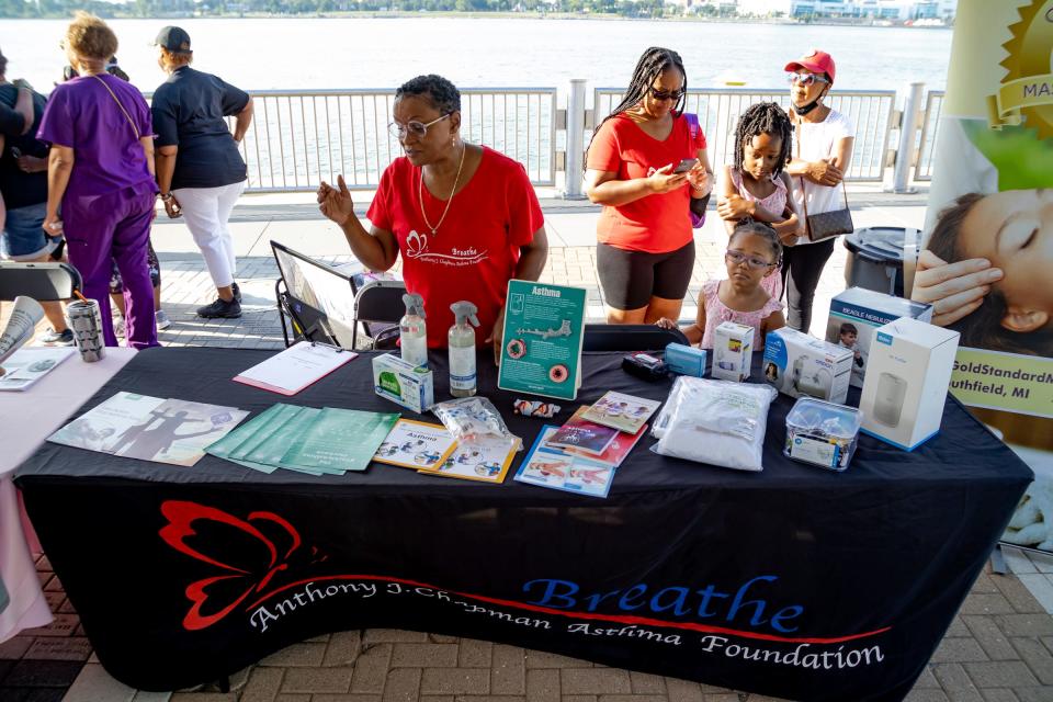 Laonis Quinn of the Breathe: Anthony J. Chapman Asthma Foundation has a display at the Ronda Walker Foundation Annual 5/10K to help shine a light on asthma awareness.