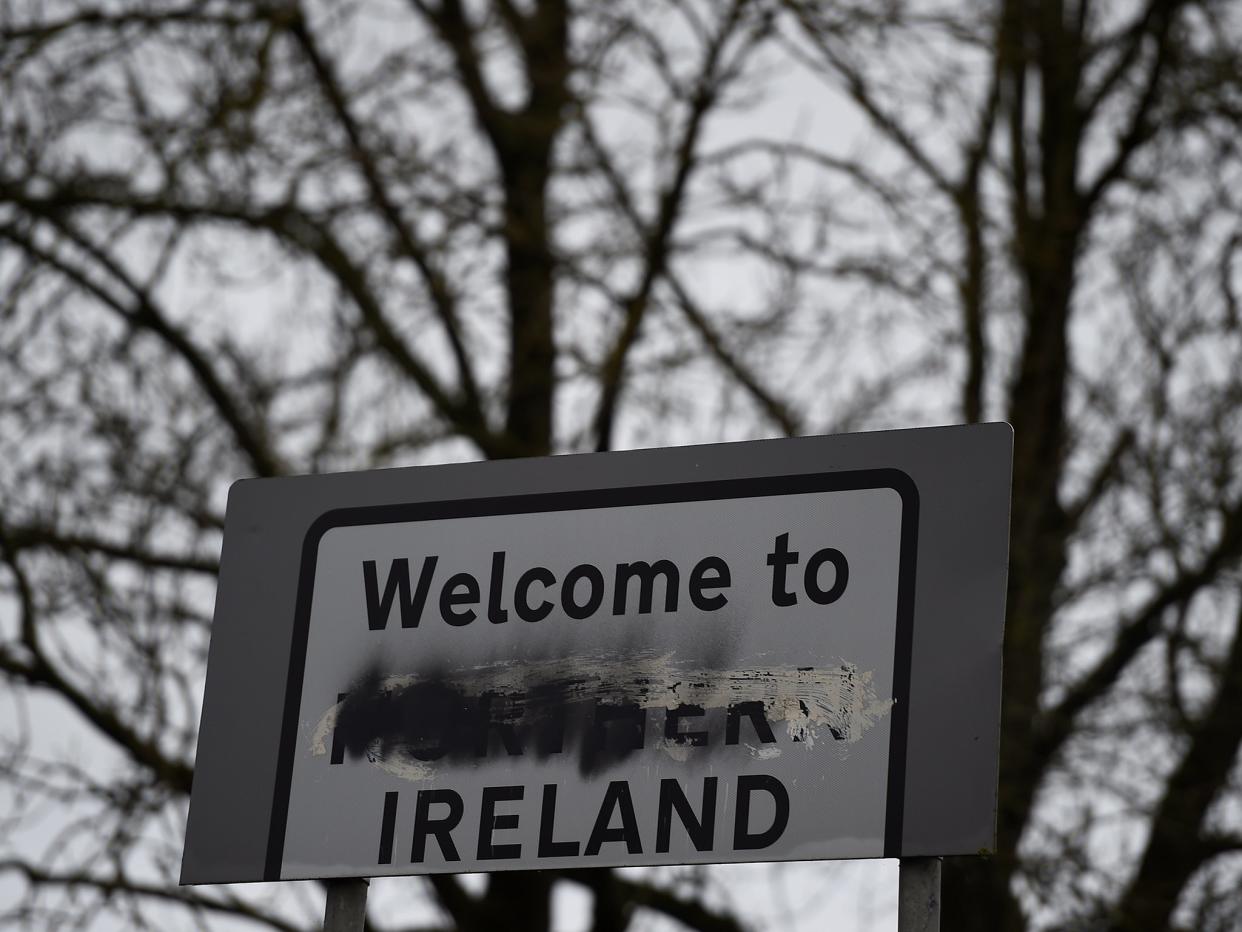 A defaced 'Welcome to Northern Ireland' sign stands on the border in Middletown, Co Armagh: Photography by Reuters/Clodagh Kilcoyne