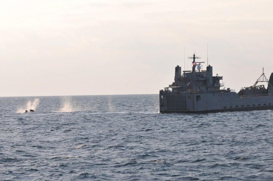 Soldiers fire an M2 .50-caliber machine gun from the aft section of the Logistical Support Vessel Gen. Frank S. Besson Jr.