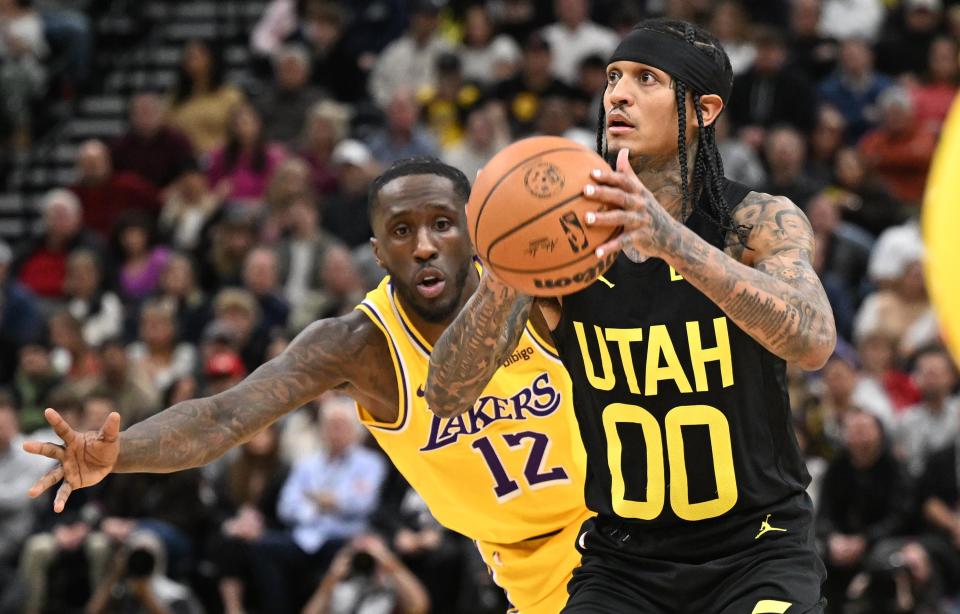 Los Angeles Lakers forward Taurean Prince (12) tries to defend Utah Jazz guard Jordan Clarkson (00) as he goes up for a shot as the Utah Jazz and the Los Angeles Lakers play at the Delta Center in Salt Lake City on Wednesday, Feb. 14, 2024. | Scott G Winterton, Deseret News