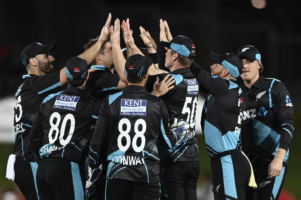 New Zealand's Jimmy Neesham celebrates his catch to dismiss India's Shreyas Iyer during their T20 cricket international in Napier, New Zealand, Tuesday, Nov. 22, 2022. (Andrew Cornaga/Photosport via AP)