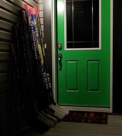 Hockey sticks are seen on a porch in tribute to the 15 youth players and personnel killed in a bus crash, in Fort Saskatchewan, Alberta, Canada April 8, 2018 in this picture obtained from social media on April 9, 2018. TWITTER/@REALDEALHOM10 via REUTERS