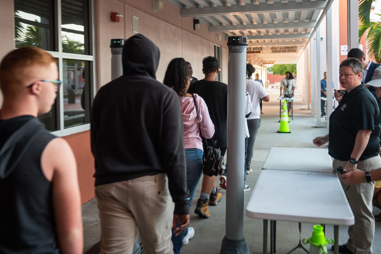 Students walked past a free-standing OpenGate metal detector on their way into John I. Leonard High School in Greenacres, in 2023.