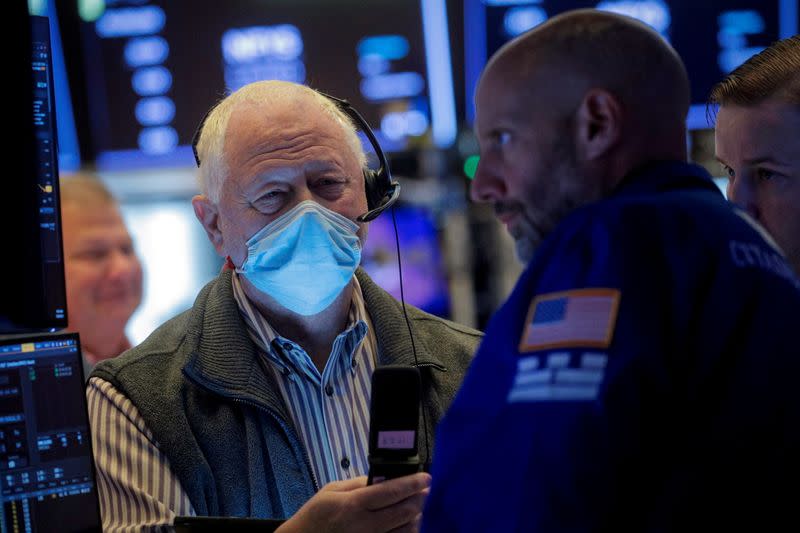 FILE PHOTO: Traders work on the floor of the NYSE in New York