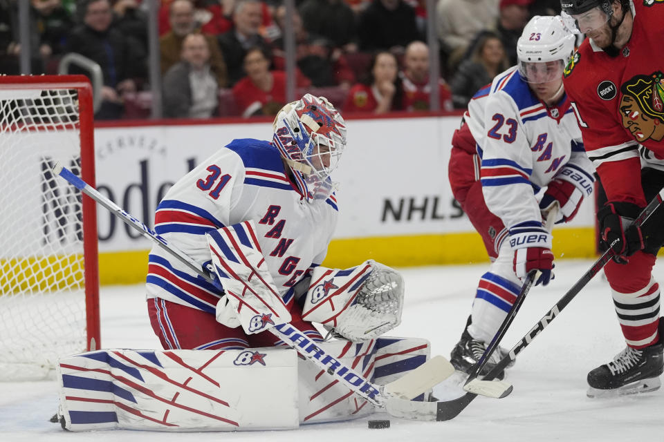 New York Rangers goaltender Igor Shesterkin makes a save against Chicago Blackhawks right wing Taylor Raddysh during the first period of an NHL hockey game, Friday, Feb. 9, 2024, in Chicago. (AP Photo/Erin Hooley)