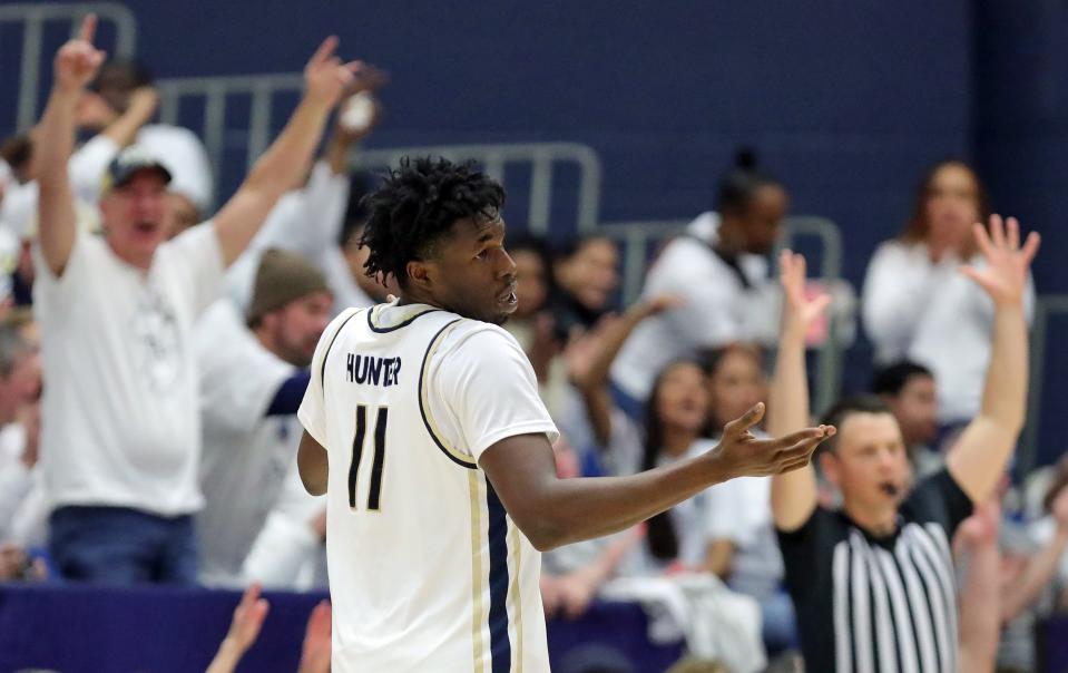 Akron Zips forward Sammy Hunter (11) celebrates after a three during the second half of an NCAA college basketball game against the Kent State Golden Flashes, Friday, Feb. 23, 2024, in Akron, Ohio.