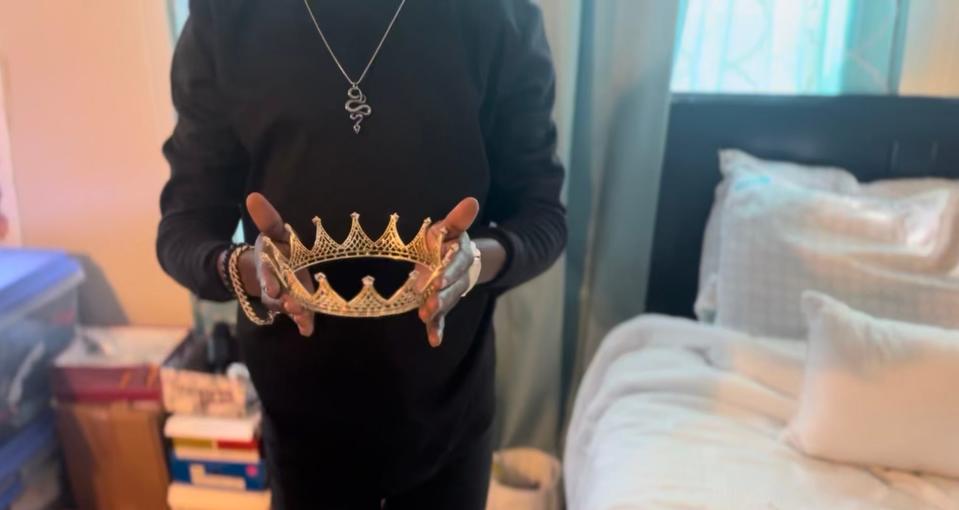 Quandarius “Chanel” Johnson, 23, holds a gold-tinted crown that she keeps in her bedroom at a transgender safe house in Tallahassee, Fla.