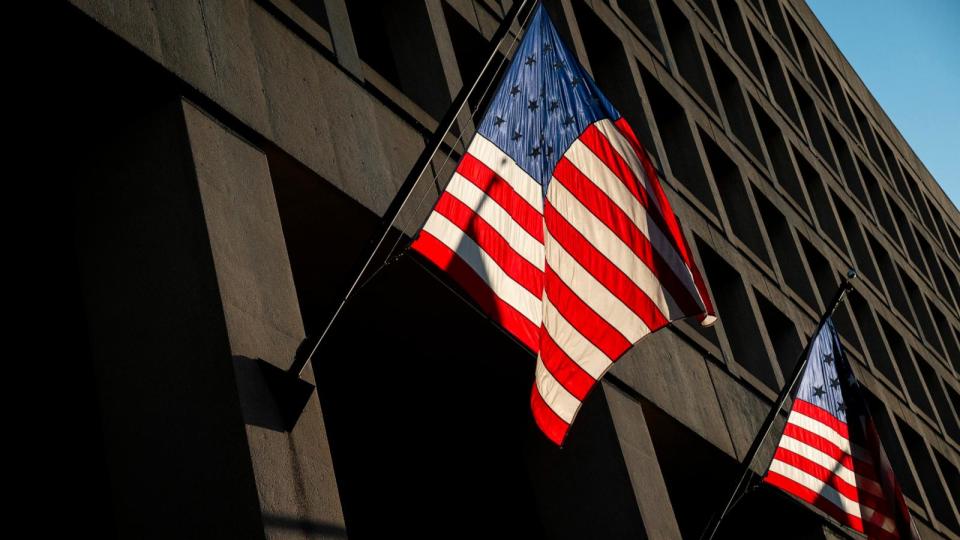 PHOTO: Sunlight illuminates flags at the U.S. Federal Bureau of Investigation (FBI) J. Edgar Hoover building, in Washington, D.C., Feb. 21, 2024. (Graeme Sloan/Sipa USA via AP)