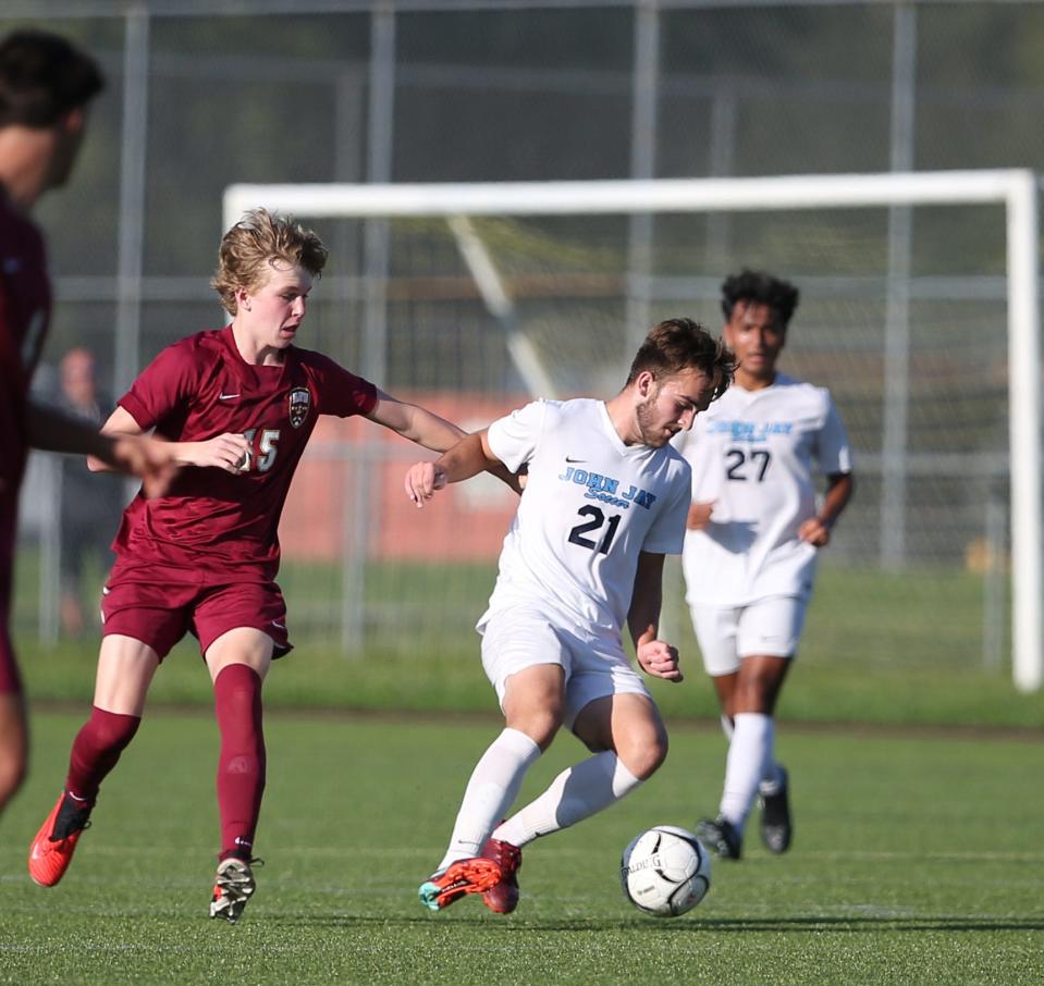 John Jay's Derek Viebrock (right) vs. Arlington.