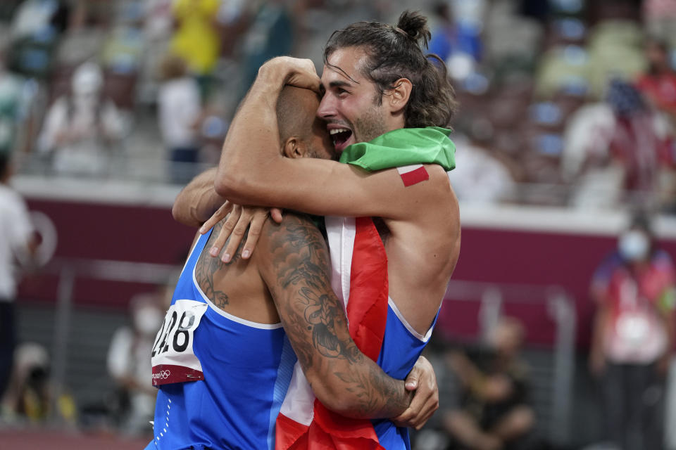 FILE - High jump gold medalist Gianmarco Tamberi, right, of Italy, congratulates compatriot Lamont Marcell Jacobs, after he won the final of the men's 100-meters at the 2020 Summer Olympics, Sunday, Aug. 1, 2021, in Tokyo. This year could be more memorable for Jacobs than his breakout 2021 when he sprinted from virtual unknown to Olympic 100-meter champion then added another surprising gold at the Tokyo Games with Italy's 4x100-meter relay team. Jacobs tells The Associated Press that "winning these next two big events would mean winning everything there is to win in athletics." (AP Photo/Matthias Schrader, File)