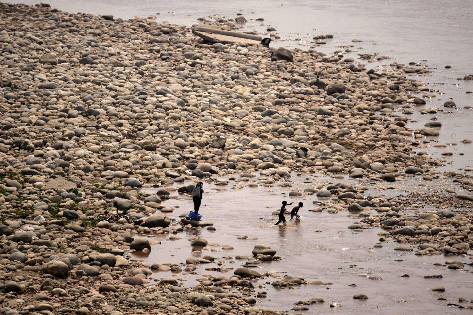 Boys try to cool off in the River Tawi on a hot summer day in Jammu, India, Thursday, May 16, 2024. (AP Photo/Channi Anand)