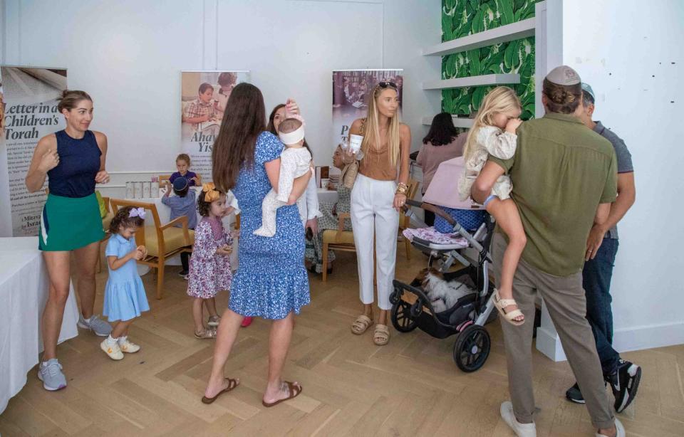 People drop by a "Mitzvah for Israel" pop-up store Thursday at The Chabad House in Palm Beach. The pop-up store allows the public to say prayers for those affected by the Hamas attacks in Israel, to write a card of support to Israeli soldiers, to don tefillin, to buy mezuzahs, to have children sign up for a letter in the Unity Torah, and to give donations to organizations helping on the ground.