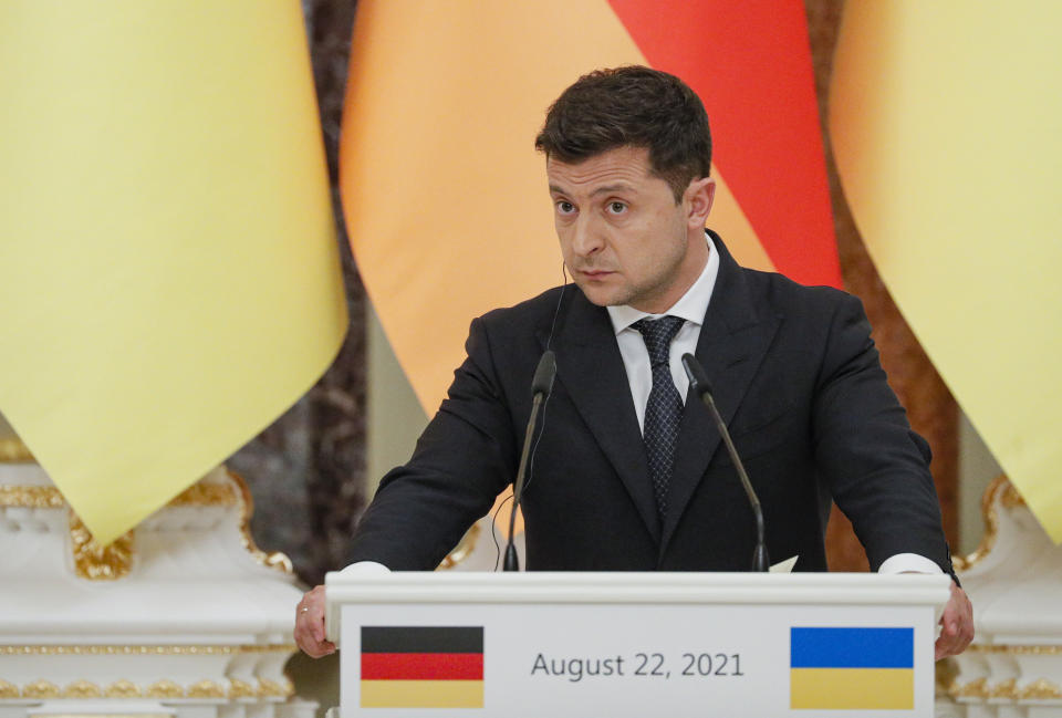 Ukrainian President Ukrainian President Volodymyr Zelenskyy attends a joint news conference with German Chancellor Angela Merkel following their talks at the Mariinsky palace in Kyiv, Ukraine, Sunday, Aug. 22, 2021. German Chancellor Angela Merkel arrived to Kyiv for a working visit to meet with top Ukrainian officials. (Sergey Dolzhenko/Pool Photo via AP)