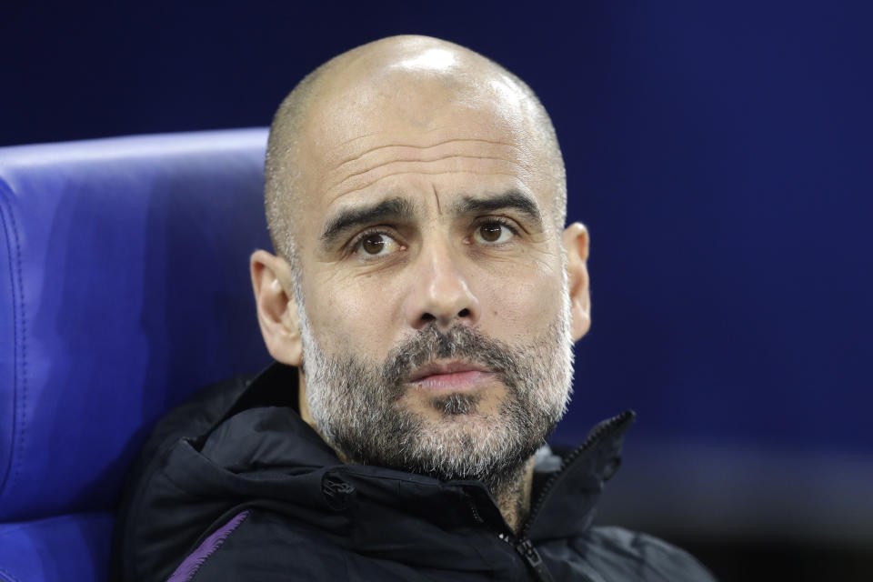 Manchester City coach Pep Guardiola takes his seat prior to the first leg, round of sixteen, Champions League soccer match between Schalke 04 and Manchester City at Veltins Arena in Gelsenkirchen, Germany, Wednesday Feb. 20, 2019. (AP Photo/Michael Probst)