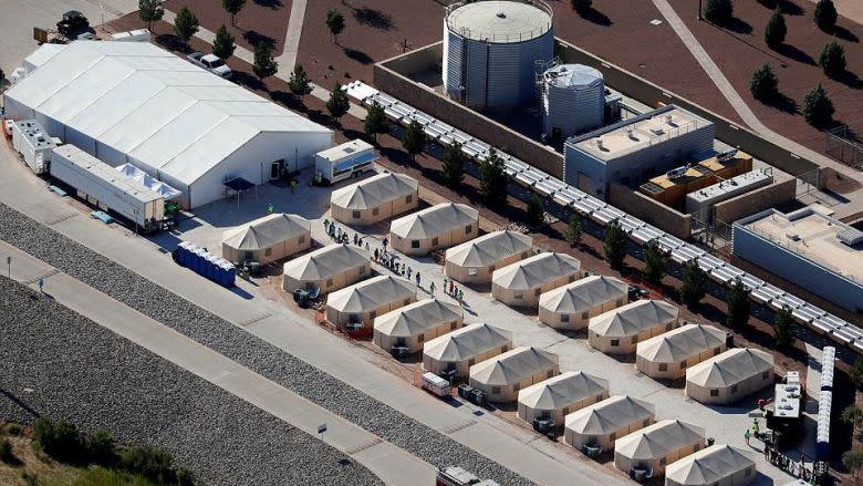 <p>Immigrant children, many of whom have been separated from their parents under a new "zero tolerance" policy by the Trump administration, are shown walking in single file between tents in their compound next to the Mexican border in Tornillo, Texas, U.S. June 18, 2018. </p>