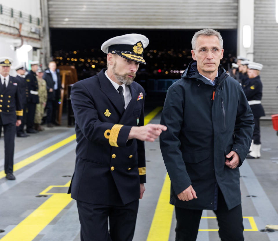 Commander of Standing NATO Maritime Group One, Anders Friis, left, talks with NATO Secretary General Jens Stoltenberg, on the Danish support ship HDMS Esbern Snare during his visit to the NATO exercise, in Trondheim, Norway, Monday Oct. 29. 2018. (Gorm Kallestad / NTB scanpix via AP)