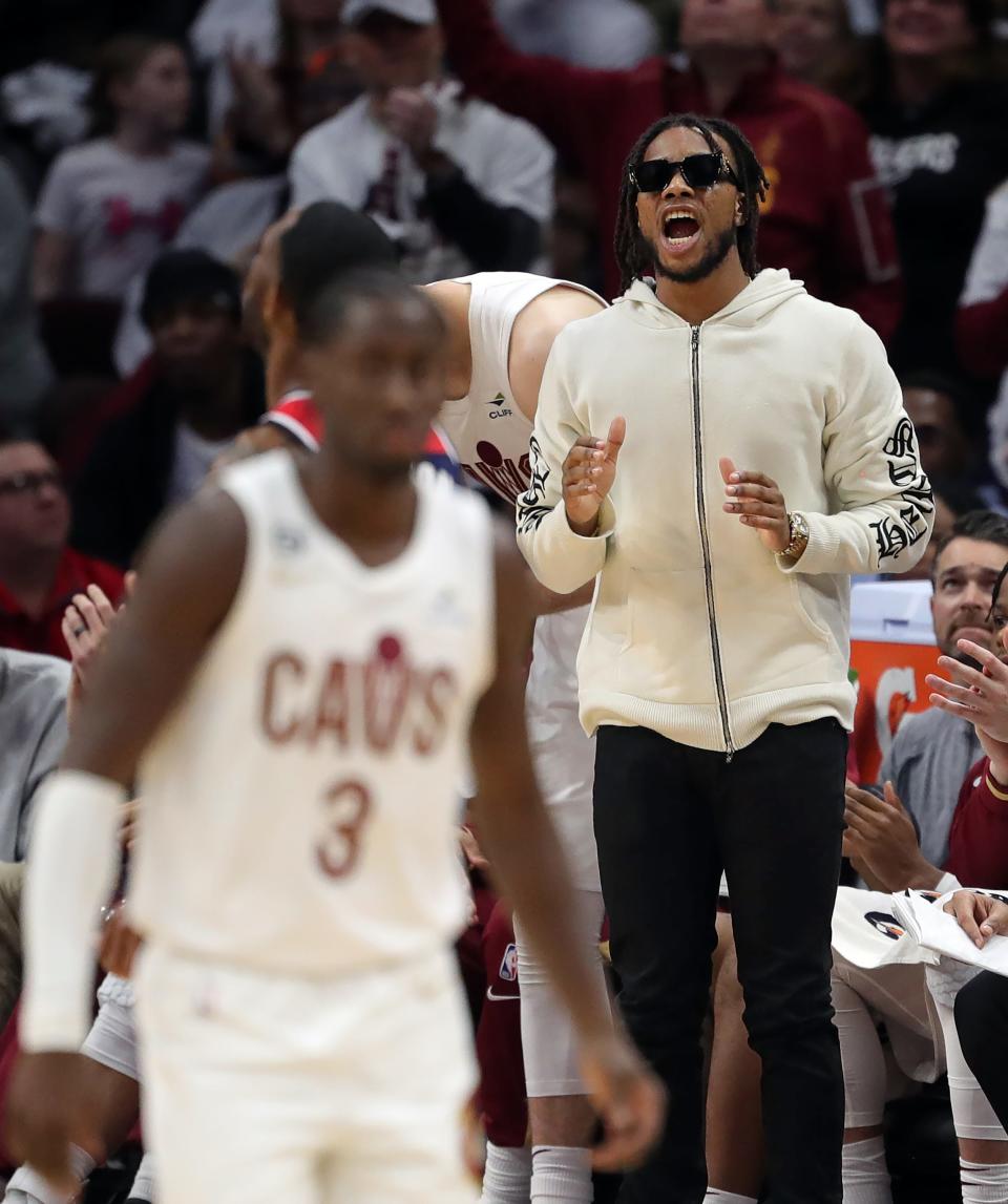 Cleveland Cavaliers guard Darius Garland cheers on his team from the bench during an overtime period of an NBA basketball game against the Washington Wizards at Rocket Mortgage FieldHouse, Sunday, Oct. 23, 2022, in Cleveland, Ohio.