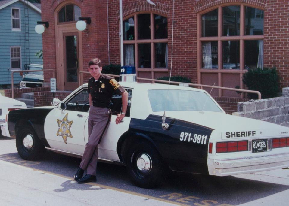 Paul Whelan poses in front of a Washtenaw County Sheriff's vehicle in this undated photo.