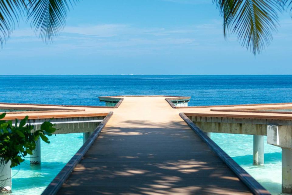 A long wooden dock in the Maldives