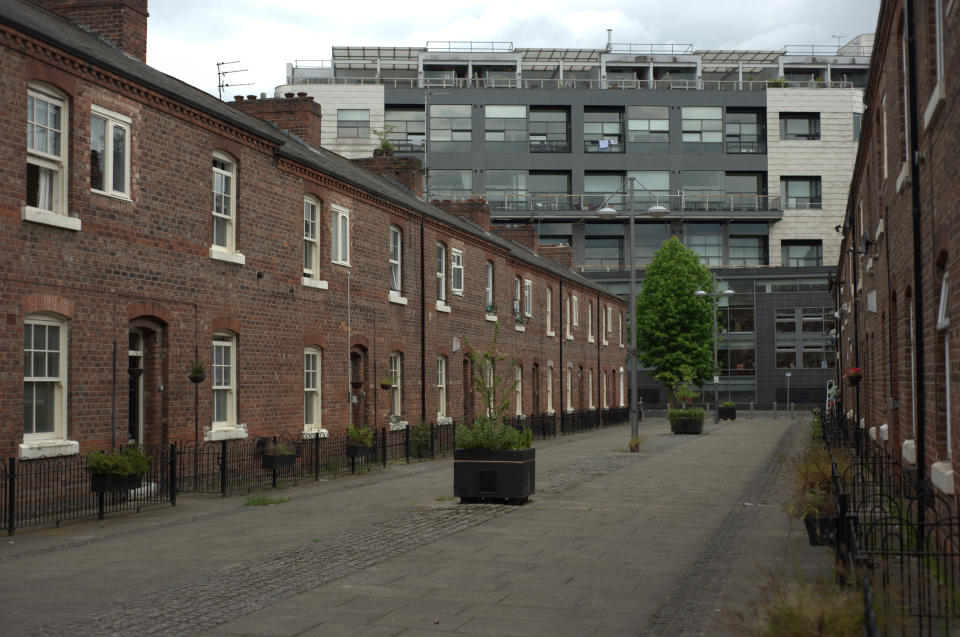 A residential street on November 27, 2014, in Manchester city centre on which are two rows of terraced houses. At the end of the row is a multi-storey block of modern flats. (Photo by Jonathan Nicholson/NurPhoto) (Photo by NurPhoto/NurPhoto via Getty Images)