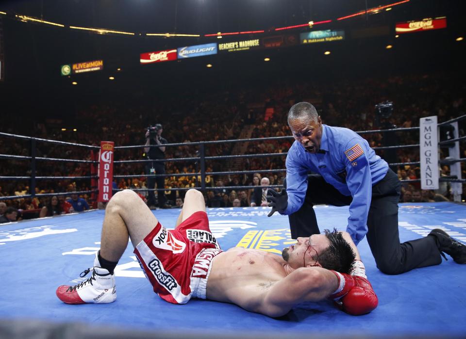 Referee Kenny Bayless gives a 10 count to Robert Guerrero after Guerrero was knocked down by Keith Thurman in a boxing match, Saturday, March 7, 2015, in Las Vegas. Thurman won by unanimous decision. (AP Photo/Eric Jamison)