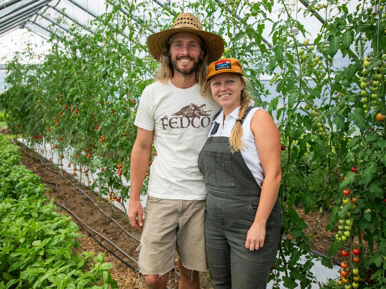 Michael Zueger and Cara Germain in a greenhouse on their Free Living Farm.