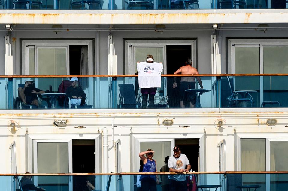 8 Passengers look out from balconies aboard the Grand Princess as it cruises a holding pattern about 25 miles off the coast of San Francisco on Sunday, March 8, 2020.