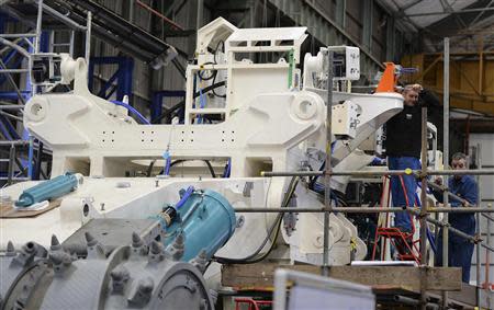 An employee of Soil Machine Dynamics (SMD) works on a subsea mining machine being built for Nautilus Minerals at Wallsend, northern England April 14, 2014. REUTERS/ Nigel Roddis