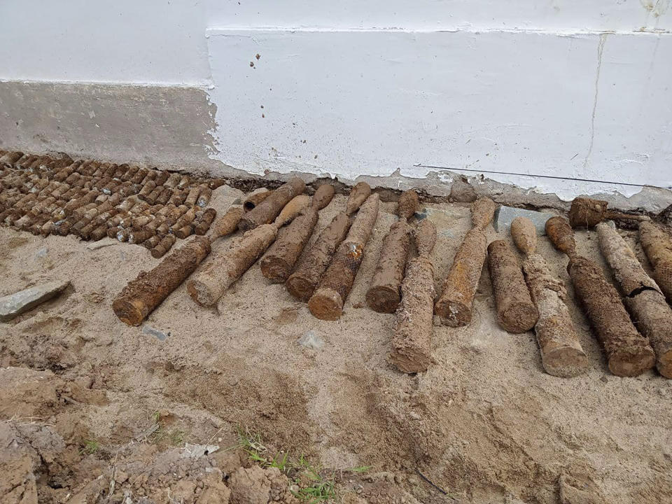 This photo released by the Cambodia Mine Action Center, CMAC, shows unexploded ordnance at Queen Kosamak High School in Kratie Province, northeastern of Phnom Penh, Cambodia, Sunday, Aug. 13, 2023. Cambodian authorities have temporarily closed the high school where thousands of pieces of unexploded ordinance from the country's nearly three decades of civil war have been unearthed. (Cambodia Mine Action Center via AP)