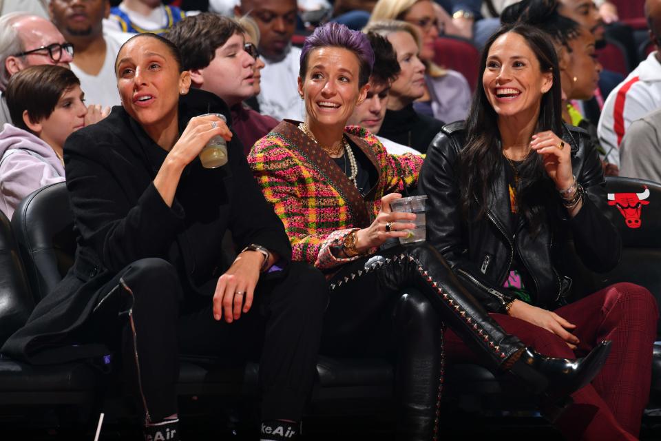 Diana Taurasi, Megan Rapinoe, and Sue Bird sit court-side during an NBA All-Star Game in Chicago, February 16, 2020.
