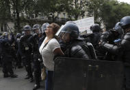 Police detain a protestor during a demonstration in Paris, France, Saturday, July 31, 2021. Demonstrators gathered in several cities in France on Saturday to protest against the COVID-19 pass, which grants vaccinated individuals greater ease of access to venues. (AP Photo/Adrienne Surprenant)