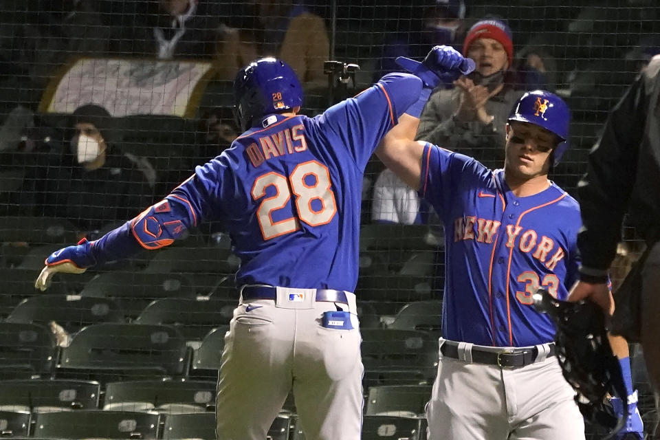 New York Mets' J.D. Davis (28) celebrates his home run off Chicago Cubs starting pitcher Jake Arrieta with James McCann (33) during the fifth inning of a baseball game Tuesday, April 20, 2021, in Chicago. (AP Photo/Charles Rex Arbogast)