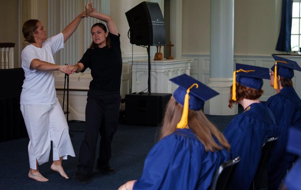 Michelle Williams and Rheann Kelly, both incarcerated women who earned their degrees from Marian University through the Women's College Partnership program, perform a tribute dance Monday, Aug. 7, 2023, in honor of Lisa Van Morrison, a fellow graduate who died weeks prior after a battle with cancer.