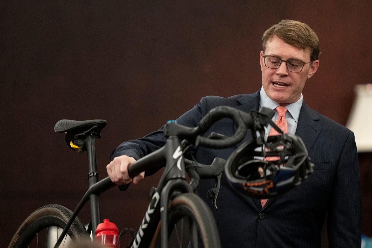 Defense attorney Rick Cofer picks up Anna "Mo" Wilson's bike Thursday while discussing DNA evidence during Kaitlyn Armstrong's murder trial.