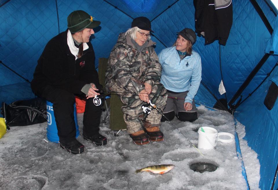 Sharon Herlache Kugler, 84, of Algoma (center) ice fishes on Green Bay with her daughter Brenda Maier (right) of Forestville and granddaughter Kelsey Kornaus of Shoreview, Minn.