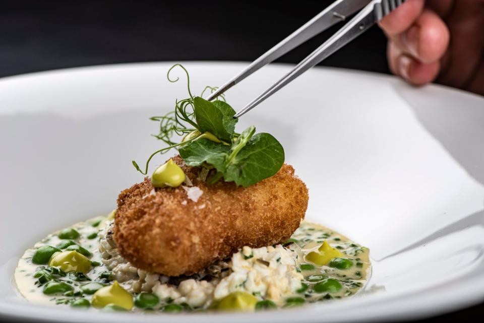 Scrubbed-up scampi: A breaded monkfish cheek with gribiche, beurre blanc sauce and peas (Daniel Hambury/Stella Pictures Ltd)