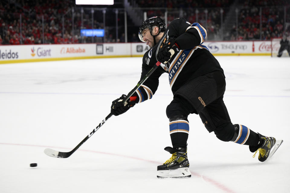 Washington Capitals left wing Alex Ovechkin (8) shoots the puck during the first period of an NHL hockey game against the Montreal Canadiens, Saturday, Dec. 31, 2022, in Washington. (AP Photo/Nick Wass)