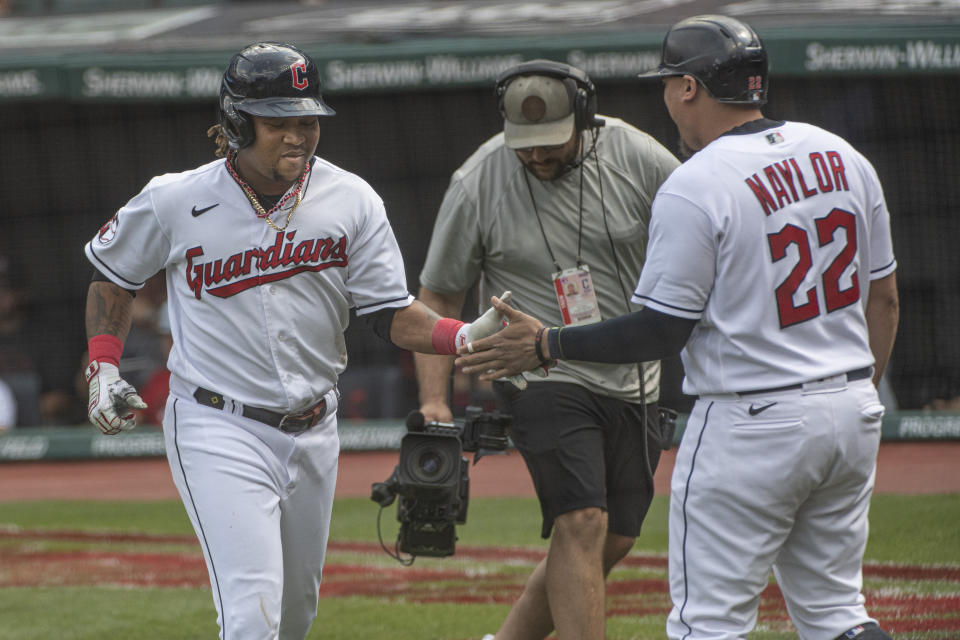 Cleveland Guardians' Jose Ramirez is congratulated by Josh Naylor after hitting a solo home run off Minnesota Twins starting pitcher Josh Winder during the first inning in the first baseball game of a doubleheader in Cleveland, Saturday, Sept. 17, 2022. (AP Photo/Phil Long)