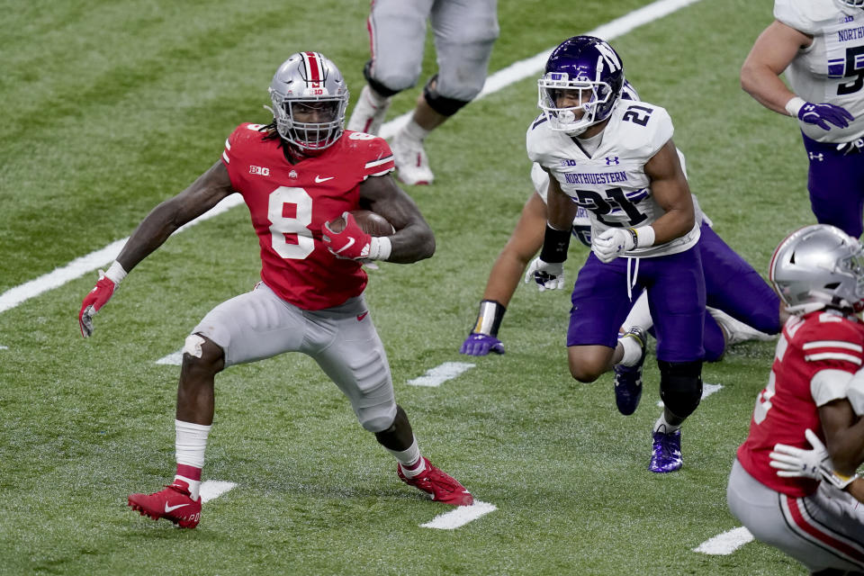 Ohio State running back Trey Sermon (8) runs for the end zone to score past Northwestern defensive back Cameron Mitchell (21) during the second half of the Big Ten championship NCAA college football game, Saturday, Dec. 19, 2020, in Indianapolis. (AP Photo/Darron Cummings)