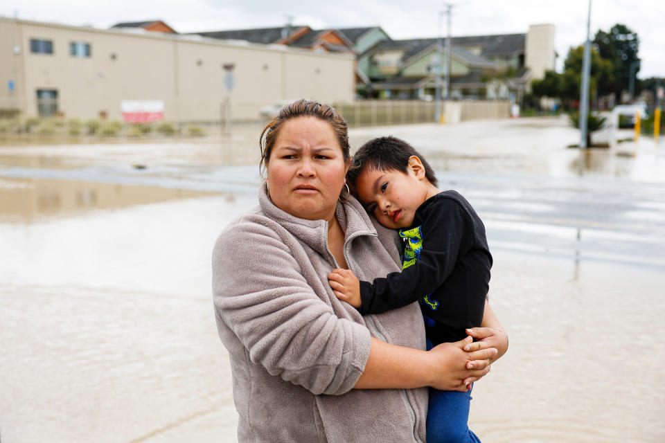 Rocio Morando holds her son David Morando, 3, in front of their home in Pajaro Valley, California, on March 12, 2023. 