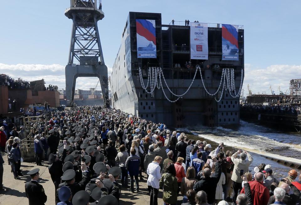 The stern of Sevastopol, a Mistral class, amphibious assault ship is launched at St.Petersburg naval shipyard on Wednesday, April 30, 2014. The stern is to be tugged to France, where where whole ship will be finished. The Russian acquisition of French Mistral class amphibious assault ships is considered to be the largest defense deal between Russia and the West since World War I. (AP Photo/Dmitry Lovetsky)