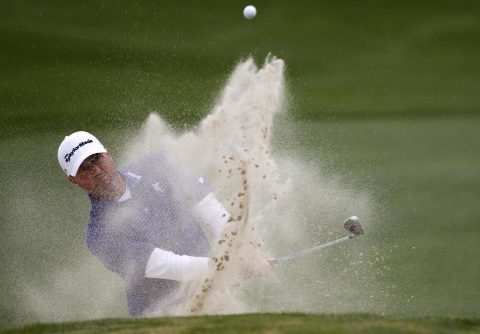 Ryan Palmer shoots out of a bunker on the eighteenth hole during the third round of the Houston Open golf tournament on Saturday, April 5, 2014, in Humble, Texas. (AP Photo/Patric Schneider)