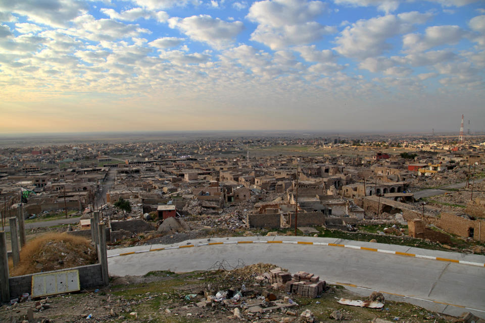 A view of deserted ruins in the northern Iraqi town of Sinjar, where the Iraqi army recently moved in to restore federal government control. Friday, Dec. 4, 2020. A new agreement aims to bring order to Iraq's northern region of Sinjar, home to the Yazidi religious minority brutalized by the Islamic State group. Since IS's fall, a tangled web of militia forces have run the area, near the Syrian border. Now their flags are coming down, and the Iraqi military has deployed in Sinjar for the first time in nearly 20 years. (AP Photo/Samya Kullab)