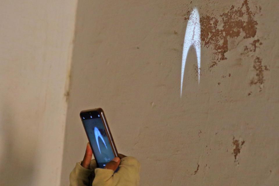 A woman security personnel take photo of shadow  of solar eclipse when it visible in the Shashthansa Yantra from historical Jantar Mantar, in Jaipur, Rajasthan, India,June 21, 2020.(Photo by Vishal Bhatnagar/NurPhoto via Getty Images)