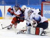 Ice Hockey - Pyeongchang 2018 Winter Olympics - Men's Quarterfinal Match - Czech Republic v U.S. - Gangneung Hockey Centre, Gangneung, South Korea - February 21, 2018 - Roman Cervenka of the Czech Republic (L) and Noah Welch and goalie Ryan Zapolski of U.S. in action. in action REUTERS/David W. Cerny